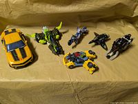 All six Transformers arranged on surface