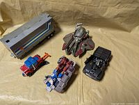 Overall lot showing trailer, jet, truck, combiner section and black car