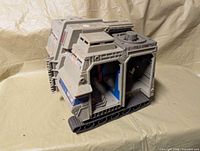 Front-left view of battle base showing exterior panels and treads