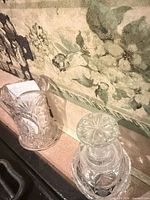 small cut crystal pitcher/creamer and bottle with stopper on countertop