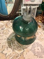 Full view of one green glass insulator showing overall shape and color