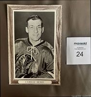 Front view showing Camille Henry portrait, border, and caption