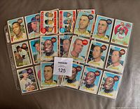 Fronts of all 28 cards fanned across binder pages