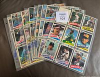 Stack of nine-pocket binder pages displaying multiple 1985 Topps Traded cards