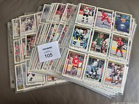 Stack of binder pages containing multiple 1991-92 OPC Premier hockey cards; MaxSold lot card visible