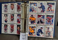 Binder open showing multiple 1991-92 Upper Deck hockey cards in nine-pocket pages