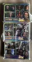 Fronts of three plastic-wrapped card stacks, top cards feature Lieutenant Torres and Female Q