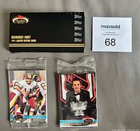 Front view of custom box and two sealed card packs