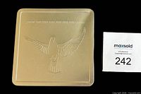 Closed metal case showing embossed dove and dates