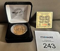 Medallion in open velvet case with COA card visible