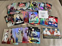 Full lot showing sealed pack and spread of rainbow-foil and base cards