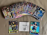 Stack of hockey cards fanned out plus separate Crosby and McDavid cards visible