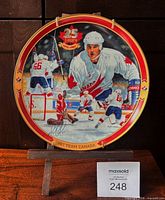 Front view of plate on stand showing artwork and rim detail