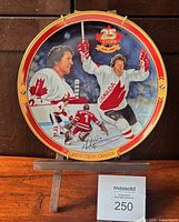 Front view of decorative plate showing artwork, numbering and overall condition