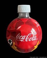 Front view of unopened spherical Coca-Cola 2010 FIFA World Cup bottle