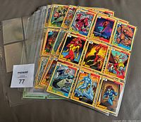 Stack of nine-pocket binder pages filled with 1991 Impel Marvel trading cards; lot tag visible
