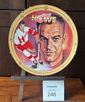 Front view of Gordie Howe decorative plate on stand with MaxSold lot card visible