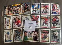 Front view of 18 autographed NHL cards in binder sheet
