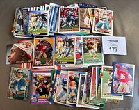 Overhead view of full lot with several stacks of NFL trading cards and sample notable players visible