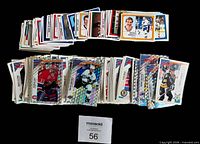 Stacks of assorted Panini hockey stickers, regular and foil variants, grouped by year