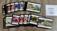 Front view of stacked and fanned OGN Origins cards showing artwork and text