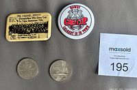 Lot overview showing both pinback buttons and both coins
