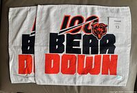 Both rally towels side by side showing full graphic and hologram tags