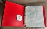 Binder open showing clear 9-pocket pages and quantity card