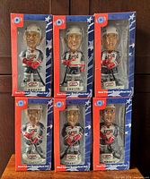 Front view of all six boxed bobbleheads