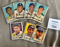 Fronts of all seven sleeved cards