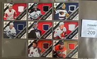 Front view of eight Game Jersey cards in binder page