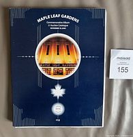 Front cover of commemorative album and auction catalogue