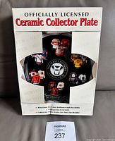 Factory box front showing officially licensed ceramic collector plate text and window with plate inside