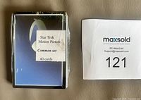 Front view of sealed 40-card Star Trek Motion Picture common set next to lot number sheet