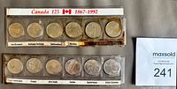 Front view of two plastic strips containing twelve 1992 Canada 125 quarters; labels for provinces visible; brown residue inside holders.