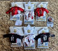 Overview of all six jerseys on stands with lot tag