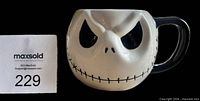 Front view showing Jack Skellington face and overall mug form