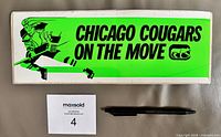 Front view of neon green Chicago Cougars bumper sticker with text and graphics