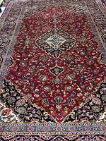Full view of red Kashan rug showing overall pattern and size