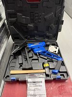 Full set in open carry case showing nailer, mallet, base, accessory box