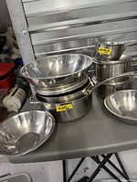 Overall lot showing nested mixing bowls, Lagostina saucepan, additional pots