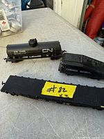 Three HO scale cars: CN tank car, CN tender, AT&SF flatcar