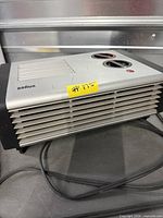 Front and side view of Braun fan heater showing vent grill and overall condition