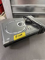 Top view of grey portable player showing lid and attached cord