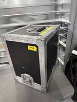 Overall view of black plywood flight case with aluminum trim and recessed handle