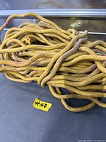 Coiled yellow heavy-duty extension cord showing length and connectors