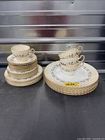 Full lot stacked showing plates, saucers, cups