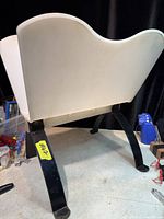 Side/back view of magazine holder showing overall structure, legs and wear