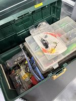 Overall view of green Plano tackle box with interior organizers and packaged tackle