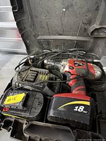 Cordless drill, two batteries, charger and case inside carry case